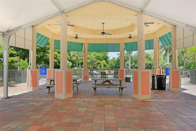 exterior space with ceiling fan and fence