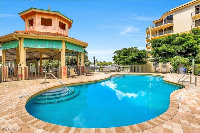 pool featuring a patio and fence