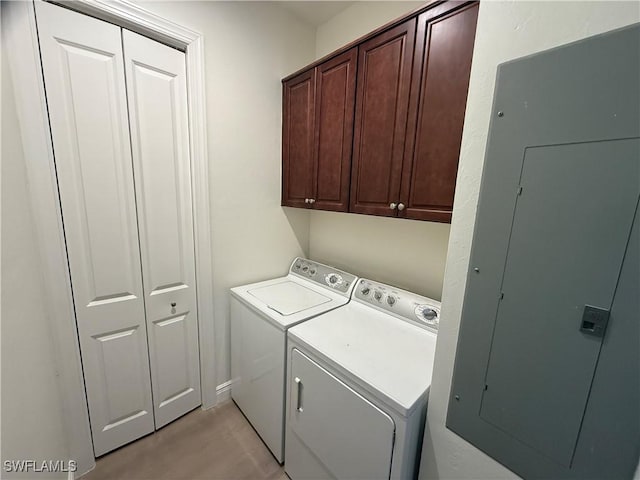 washroom with cabinet space and washer and clothes dryer