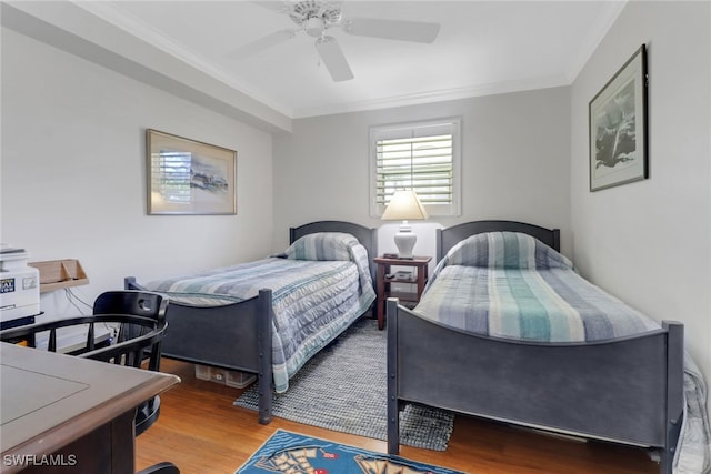 bedroom featuring a ceiling fan, crown molding, and wood finished floors