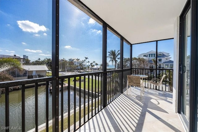 sunroom / solarium with a water view