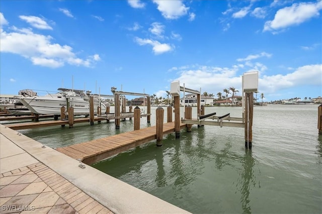 view of dock with boat lift and a water view