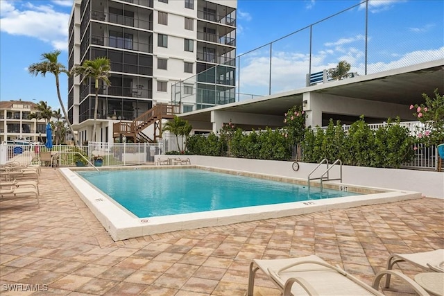 pool featuring a patio and fence