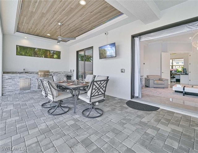 view of patio with outdoor dining space and a ceiling fan