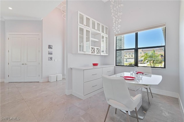 dining space with crown molding, recessed lighting, baseboards, and marble finish floor