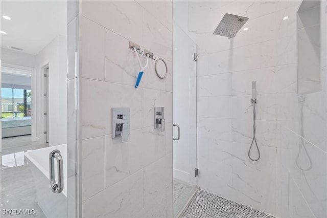 bathroom with recessed lighting and a marble finish shower