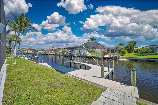 dock area with boat lift, a residential view, a water view, and a lawn