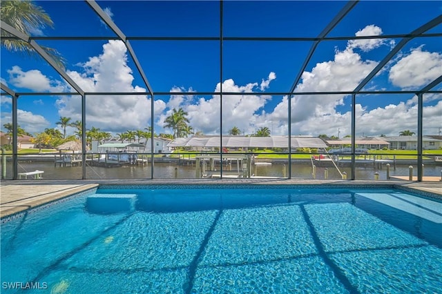 pool featuring glass enclosure, a water view, and a boat dock