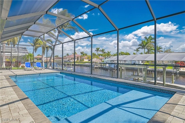 pool with a patio, a water view, a residential view, and a lanai