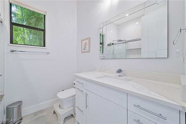 bathroom featuring baseboards, toilet, a stall shower, and vanity