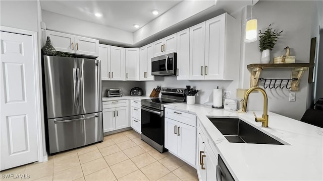10139 Colonial Country Club Blvd S Unit 1006, Fort Myers, FL 33913 - kitchen featuring white cabinets, a sink, light tile patterned floors, and appliances with stainless steel finishes