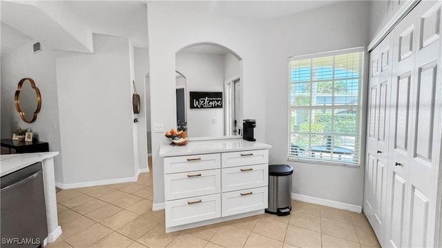 10139 Colonial Country Club Blvd S Unit 1006, Fort Myers, FL 33913 - kitchen with stainless steel dishwasher, light countertops, arched walkways, and light tile patterned floors