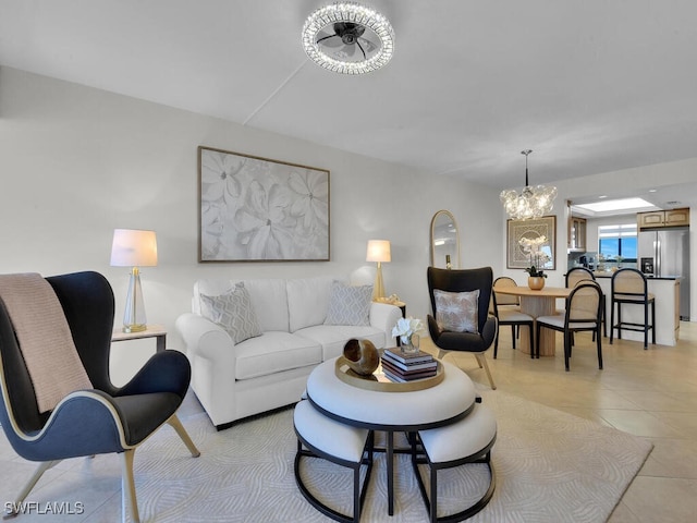 living area featuring light tile patterned floors and a chandelier