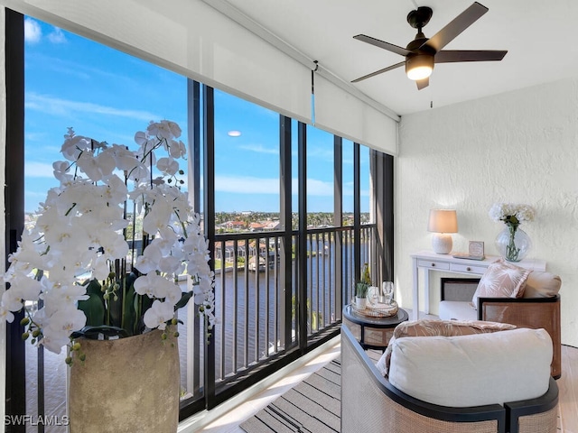 interior space featuring a water view and a ceiling fan