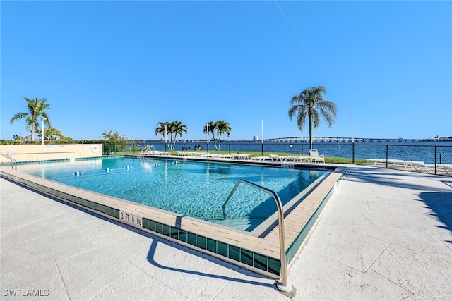 community pool with a patio and a water view