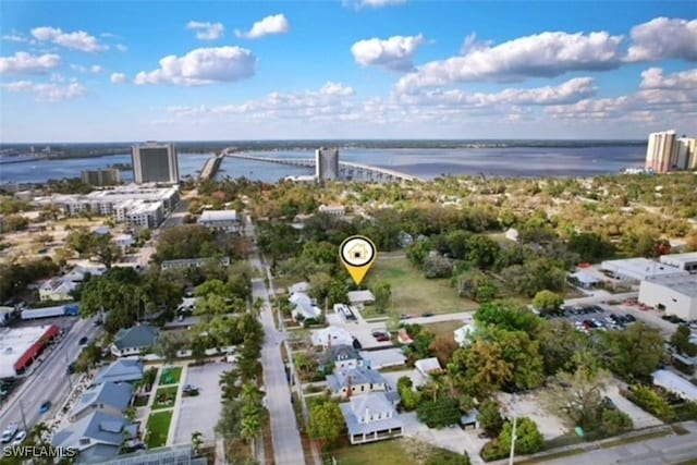 birds eye view of property featuring a view of city and a water view