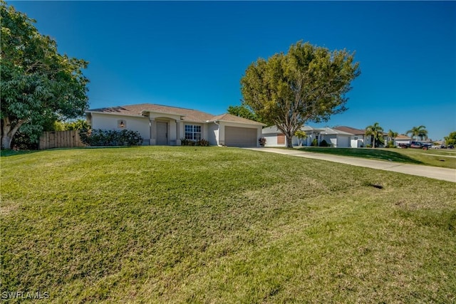 ranch-style home featuring concrete driveway, an attached garage, fence, and a front lawn