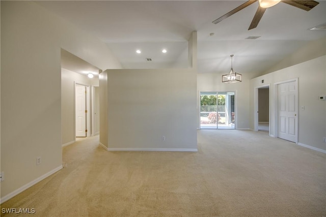 unfurnished room featuring visible vents, baseboards, ceiling fan, light colored carpet, and vaulted ceiling