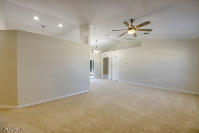 empty room with a ceiling fan, visible vents, baseboards, vaulted ceiling, and light colored carpet