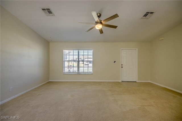 empty room with ceiling fan, baseboards, visible vents, and light carpet