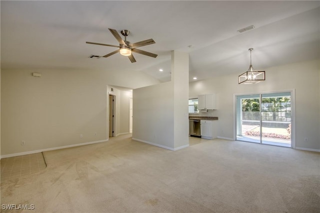 unfurnished living room with lofted ceiling, visible vents, and light carpet