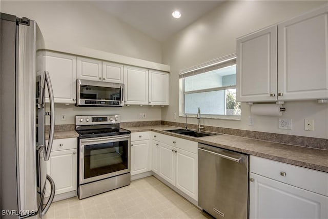 kitchen featuring recessed lighting, white cabinets, appliances with stainless steel finishes, and a sink