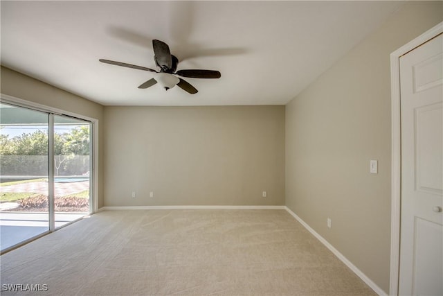 empty room featuring baseboards, light carpet, and ceiling fan