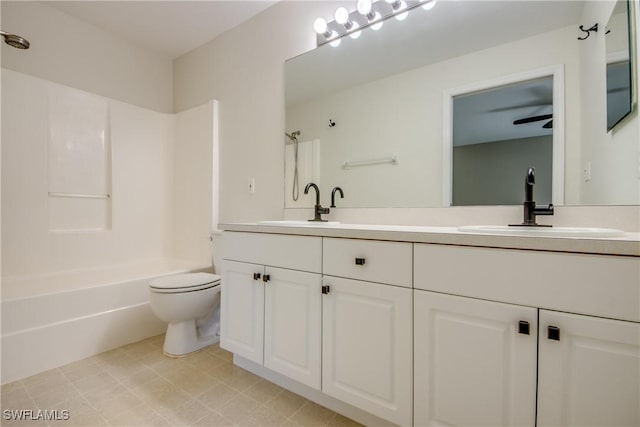 bathroom featuring double vanity, toilet, tub / shower combination, and a sink