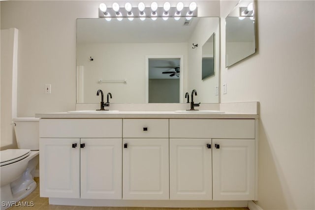 full bath featuring a sink, toilet, and double vanity