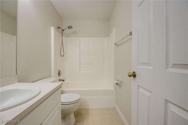 bathroom featuring tile patterned floors, toilet, vanity, baseboards, and shower / bathtub combination