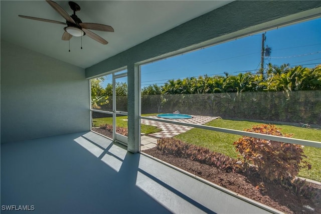 sunroom / solarium featuring a ceiling fan and vaulted ceiling