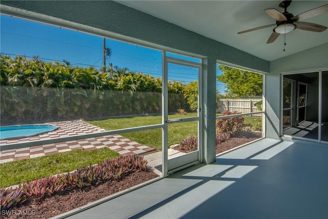 sunroom featuring lofted ceiling and a ceiling fan