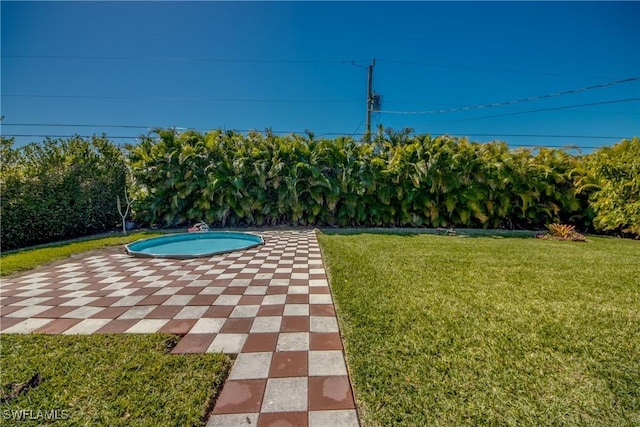 view of pool featuring a yard and a patio area