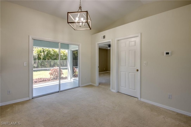 unfurnished room featuring baseboards, lofted ceiling, and carpet floors