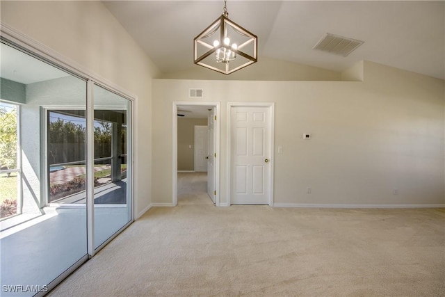 unfurnished room featuring visible vents, light colored carpet, baseboards, and lofted ceiling