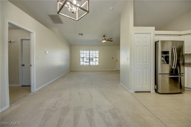 interior space featuring visible vents, light colored carpet, a ceiling fan, and baseboards