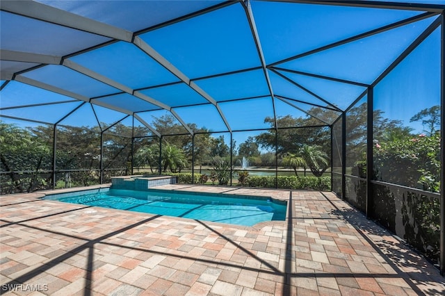 view of pool with glass enclosure, a patio, and a pool with connected hot tub
