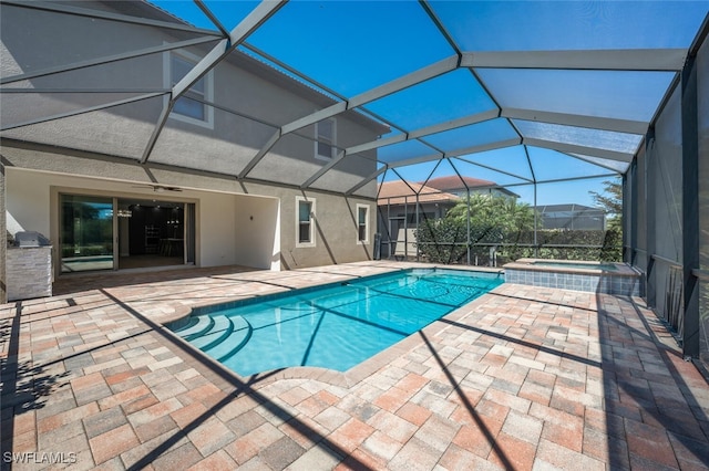view of pool featuring a patio, a lanai, and a pool with connected hot tub