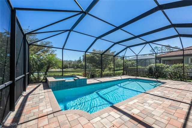 view of swimming pool featuring a patio, a pool with connected hot tub, and a lanai
