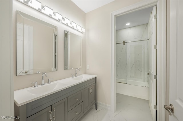 full bath featuring double vanity, marble finish floor, enclosed tub / shower combo, and a sink