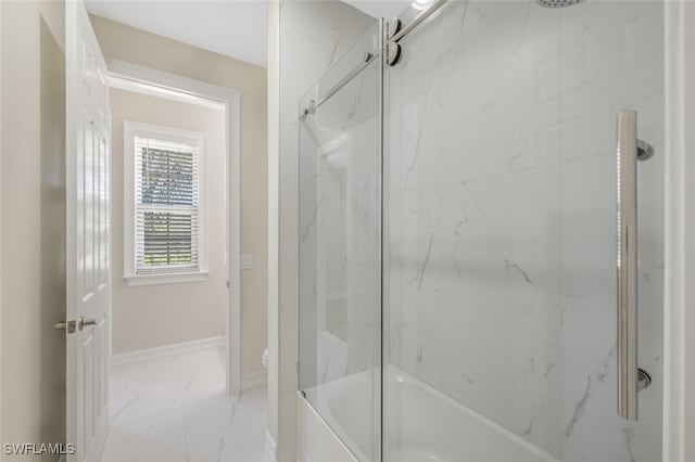 full bathroom featuring baseboards, bath / shower combo with glass door, marble finish floor, and toilet