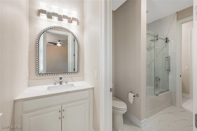full bath with toilet, marble finish floor, a ceiling fan, shower / bath combination with glass door, and vanity