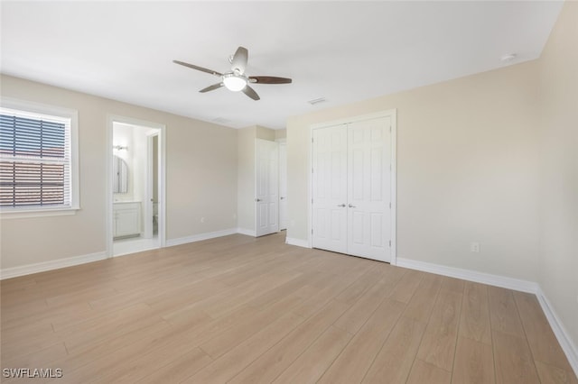 unfurnished bedroom with ceiling fan, a closet, baseboards, and light wood-style flooring