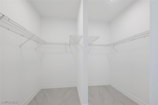 spacious closet with marble finish floor