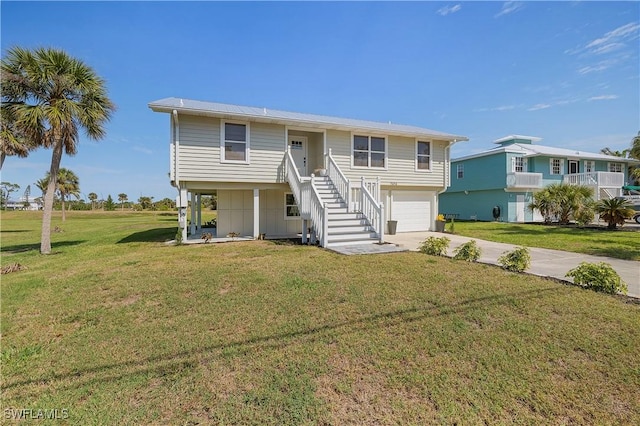 coastal home with stairs, a front yard, a garage, and driveway