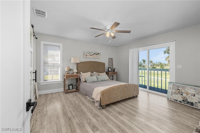 bedroom with visible vents, light wood finished floors, baseboards, and access to outside