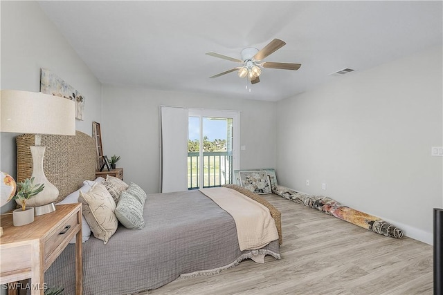 bedroom featuring access to exterior, visible vents, a ceiling fan, and wood finished floors