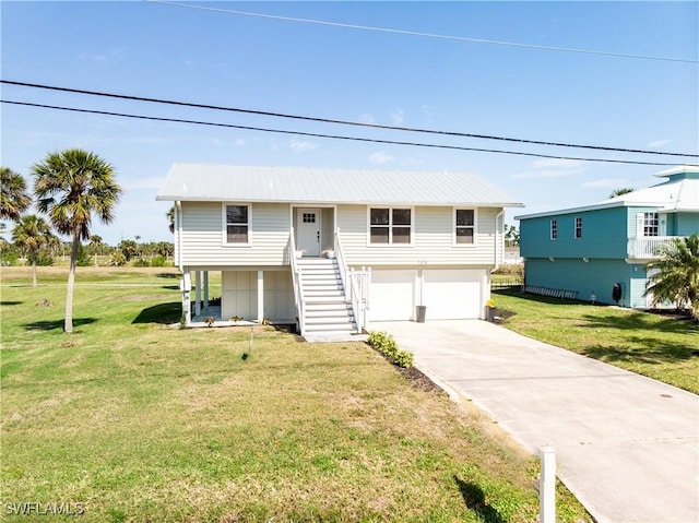 view of front of property with driveway, an attached garage, stairs, and a front lawn