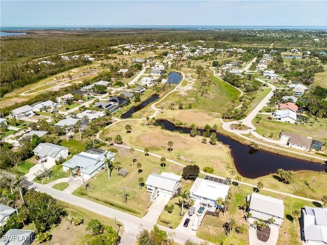 drone / aerial view featuring a residential view and a water view