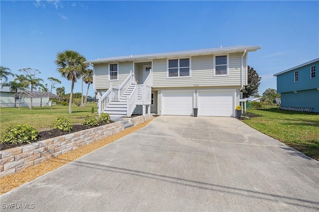 view of front of property featuring an attached garage, concrete driveway, and a front yard